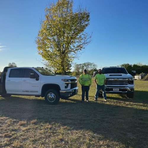 Men standing with trucks
